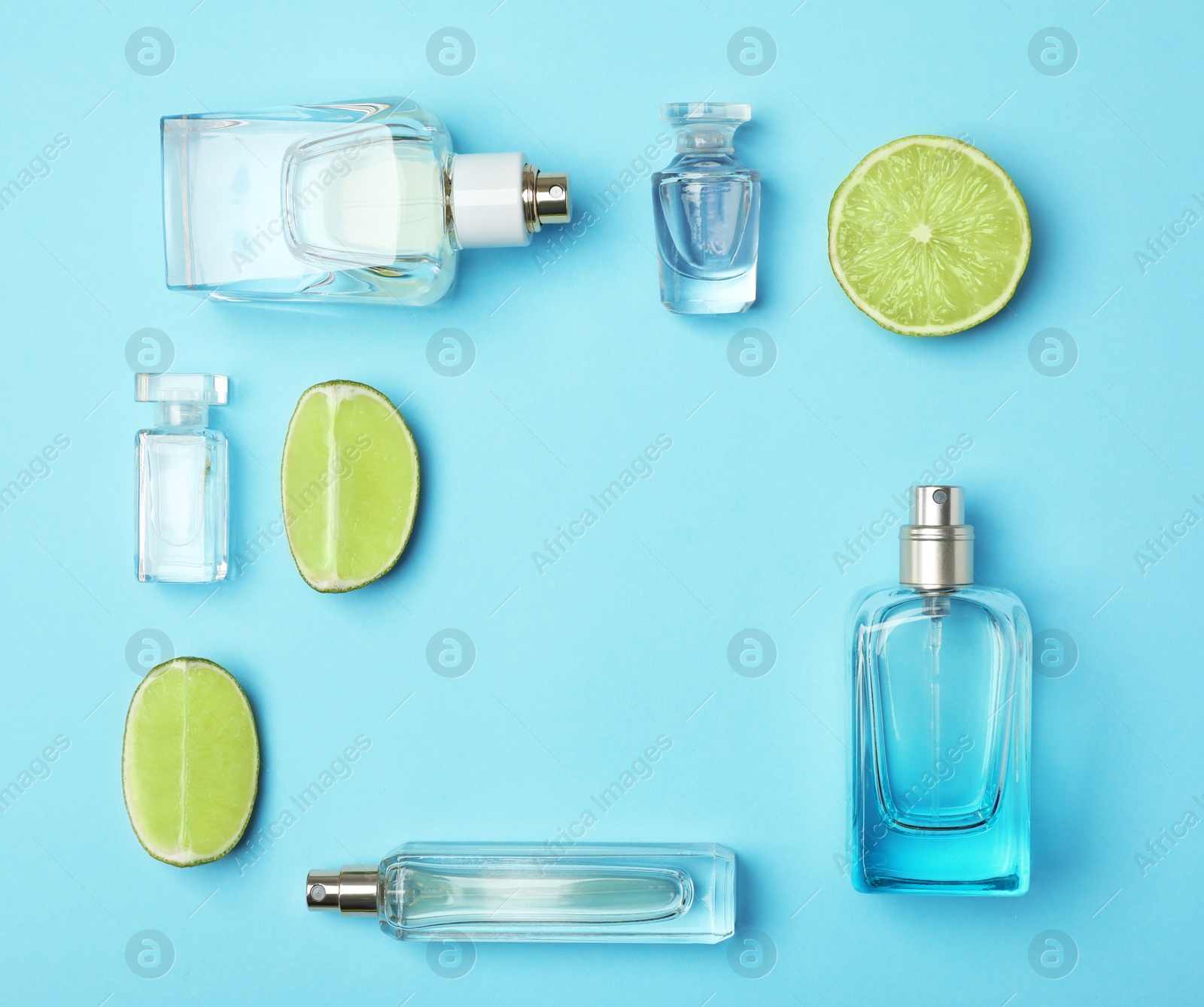 Photo of Flat lay composition with bottles of perfume and lime on color background