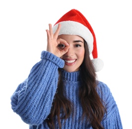 Beautiful woman wearing Santa Claus hat on white background