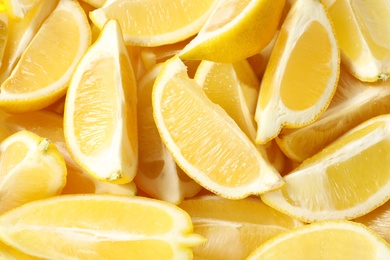 Photo of Many fresh juicy lemon slices as background, closeup