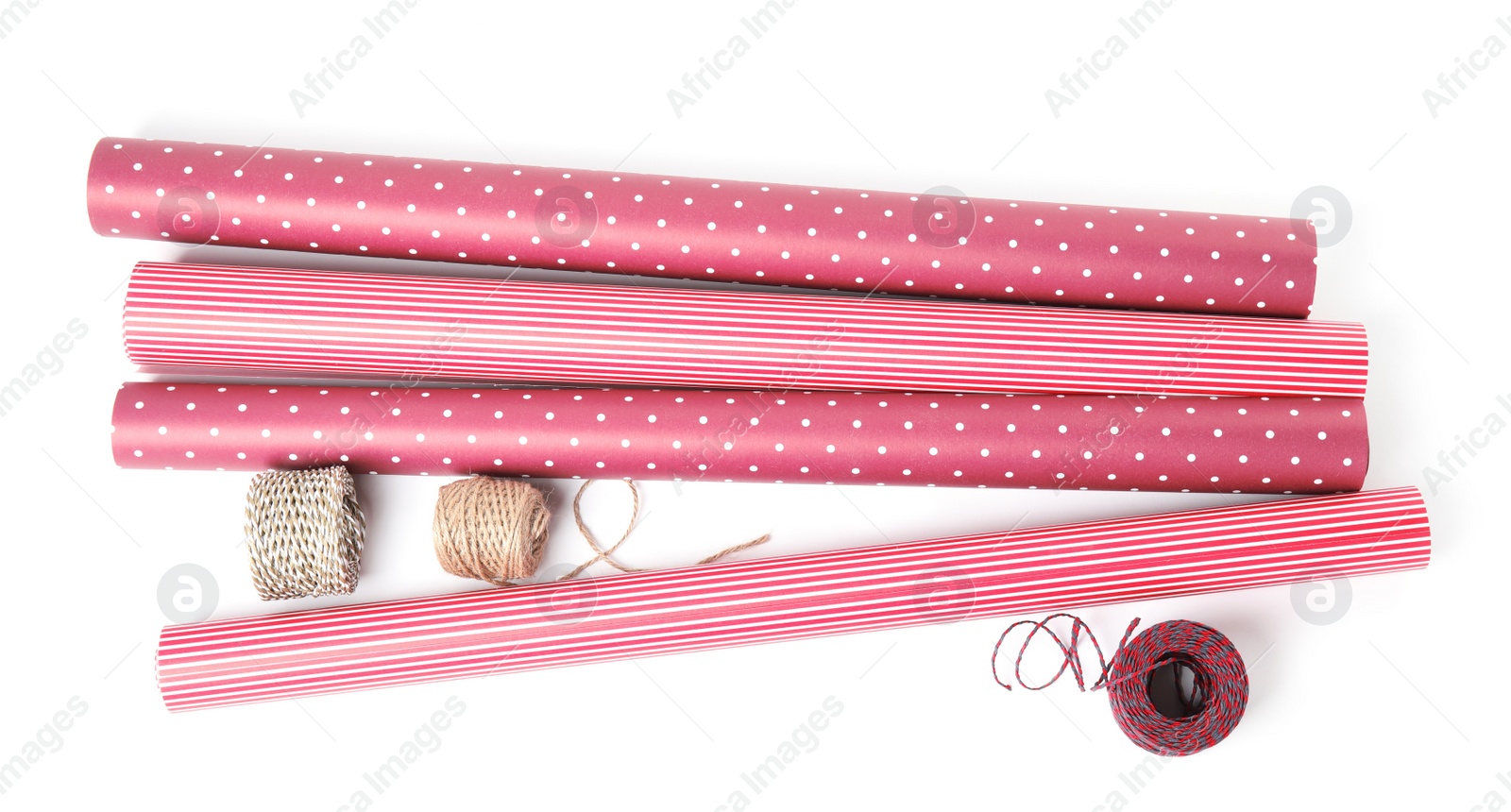 Photo of Different colorful wrapping paper rolls and ropes on white background, top view