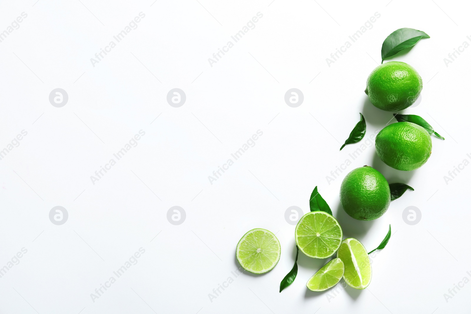 Photo of Fresh ripe green limes on white background, top view