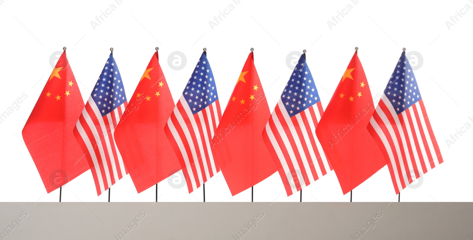 Photo of Many USA and China flags on white background. International relations