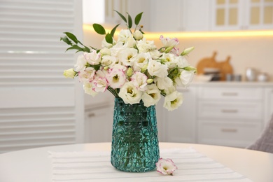 Bouquet of beautiful flowers on table in kitchen. Interior design