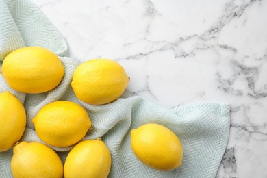 Fresh lemons and leaf on white marble table, top view. Space for table