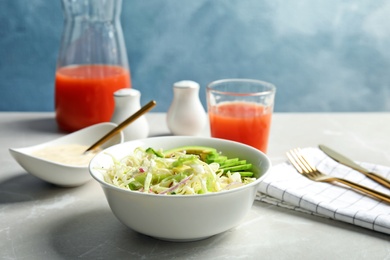 Photo of Bowl with healthy cabbage salad on marble table