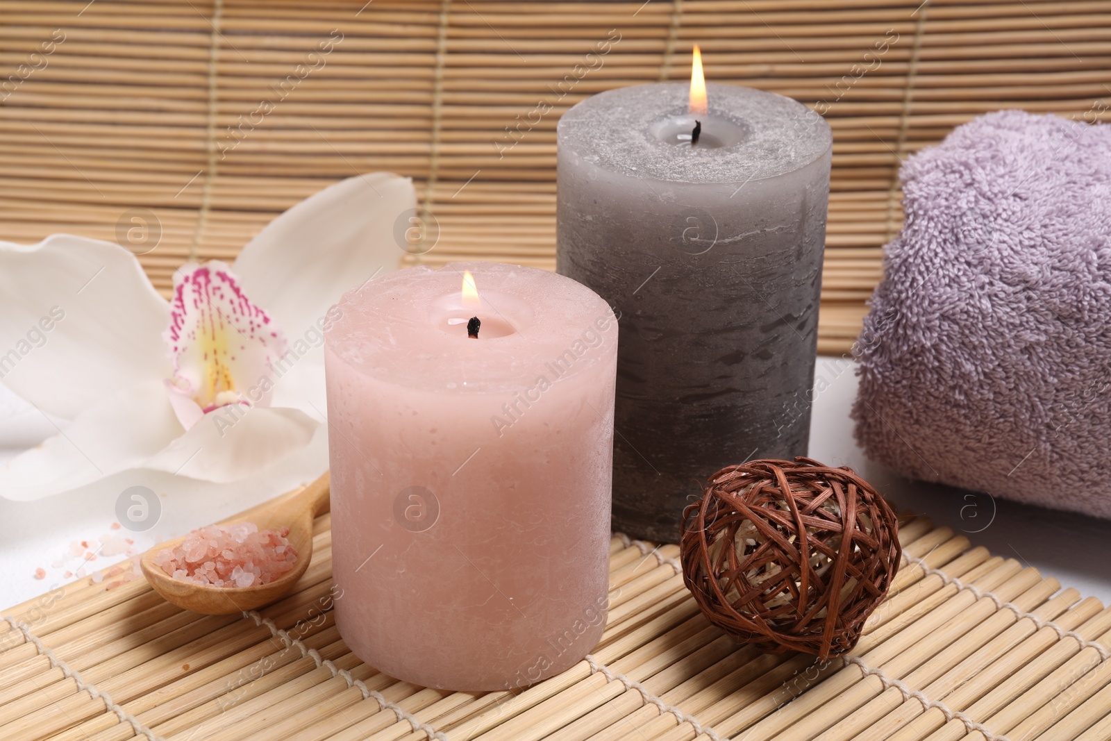 Photo of Composition with spa products, beautiful flower and burning candle on white table