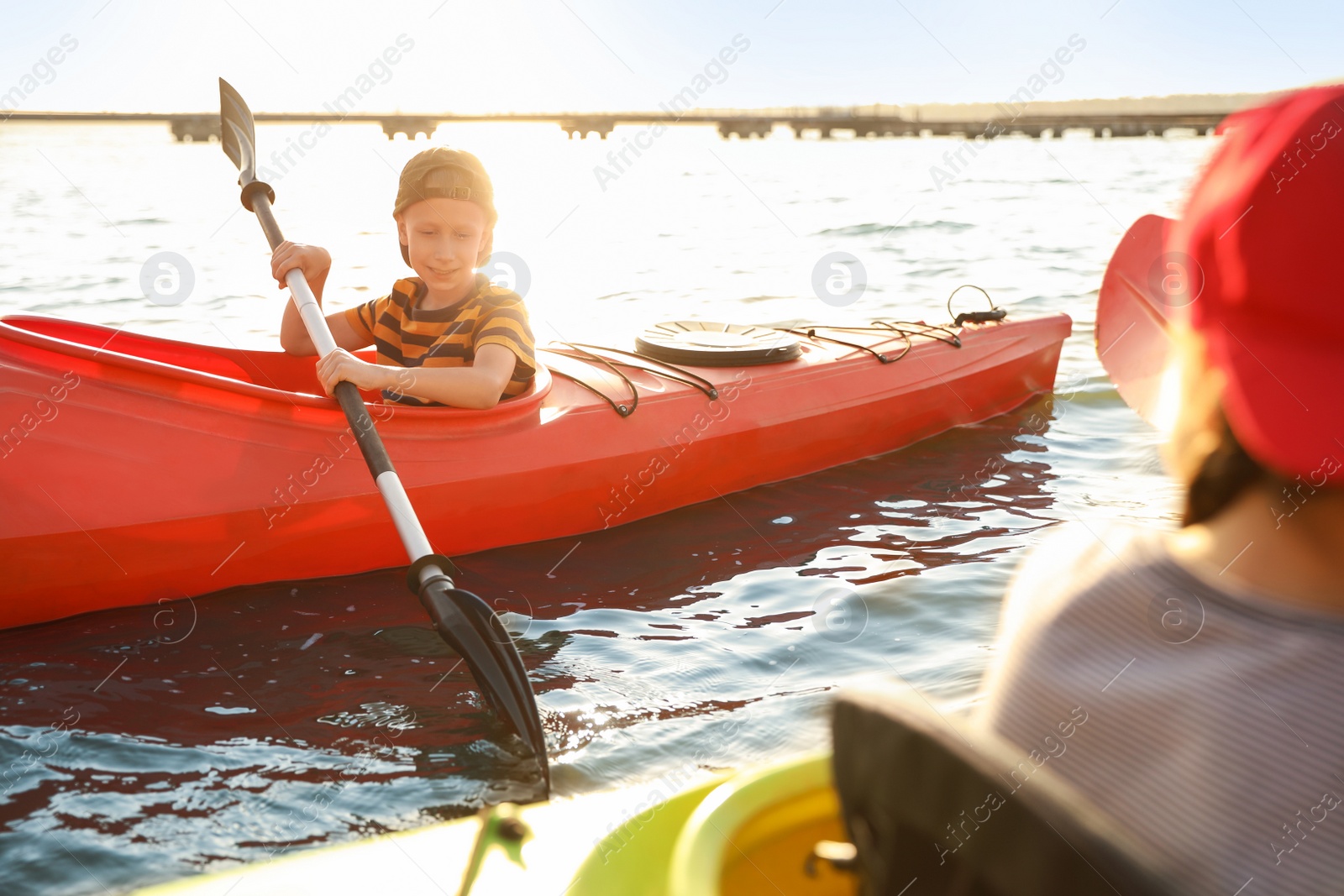 Photo of Little children kayaking on river. Summer camp activity