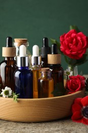 Photo of Aromatherapy. Different essential oils and flowers on wooden table