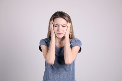 Photo of Portrait of stressed young woman on light background