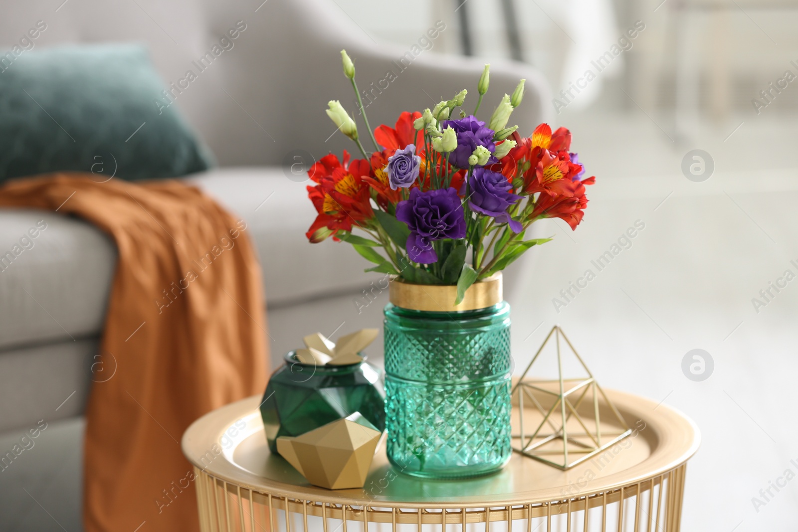 Photo of Glass vase with fresh flowers on table in living room