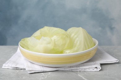 Cooked leaves for stuffed cabbage rolls on light grey table