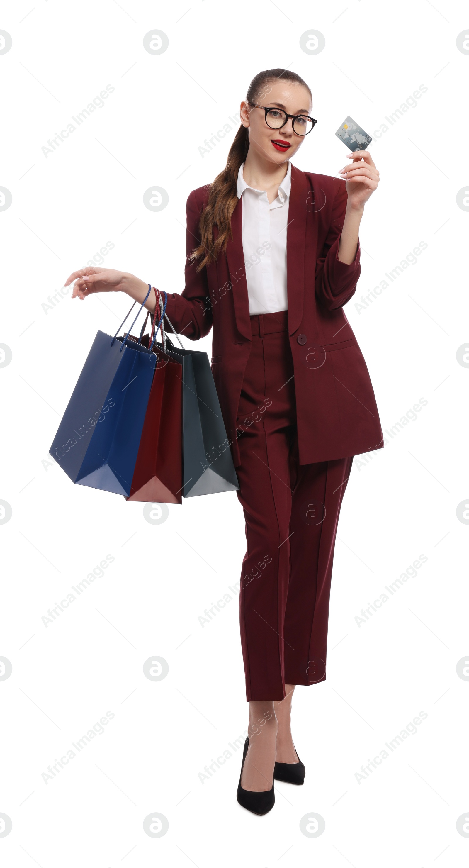 Photo of Stylish young businesswoman with shopping bags and credit card on white background