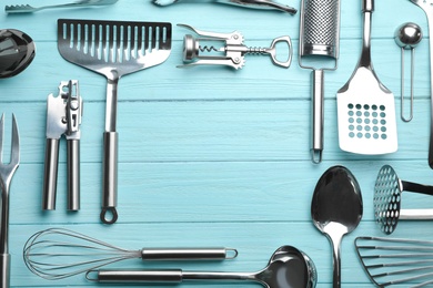 Flat lay composition with different kitchen utensils on color background, space for text