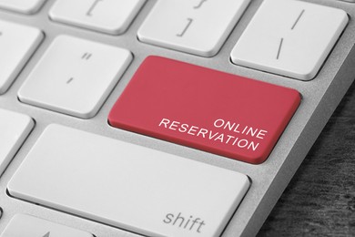 Red button with text Online Reservation on keyboard, closeup view