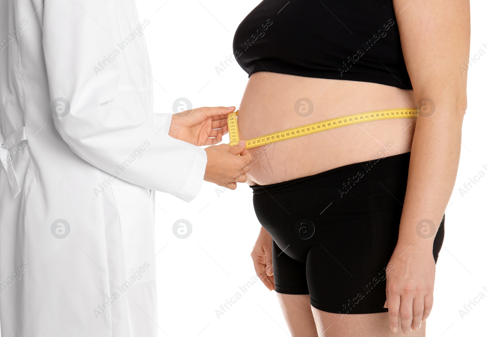 Photo of Doctor measuring fat woman's waist on white background, closeup. Weight loss