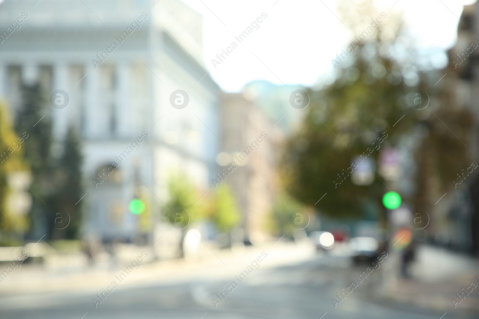 Photo of Blurred view of quiet city street empty road on sunny day