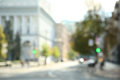 Photo of Blurred view of quiet city street empty road on sunny day