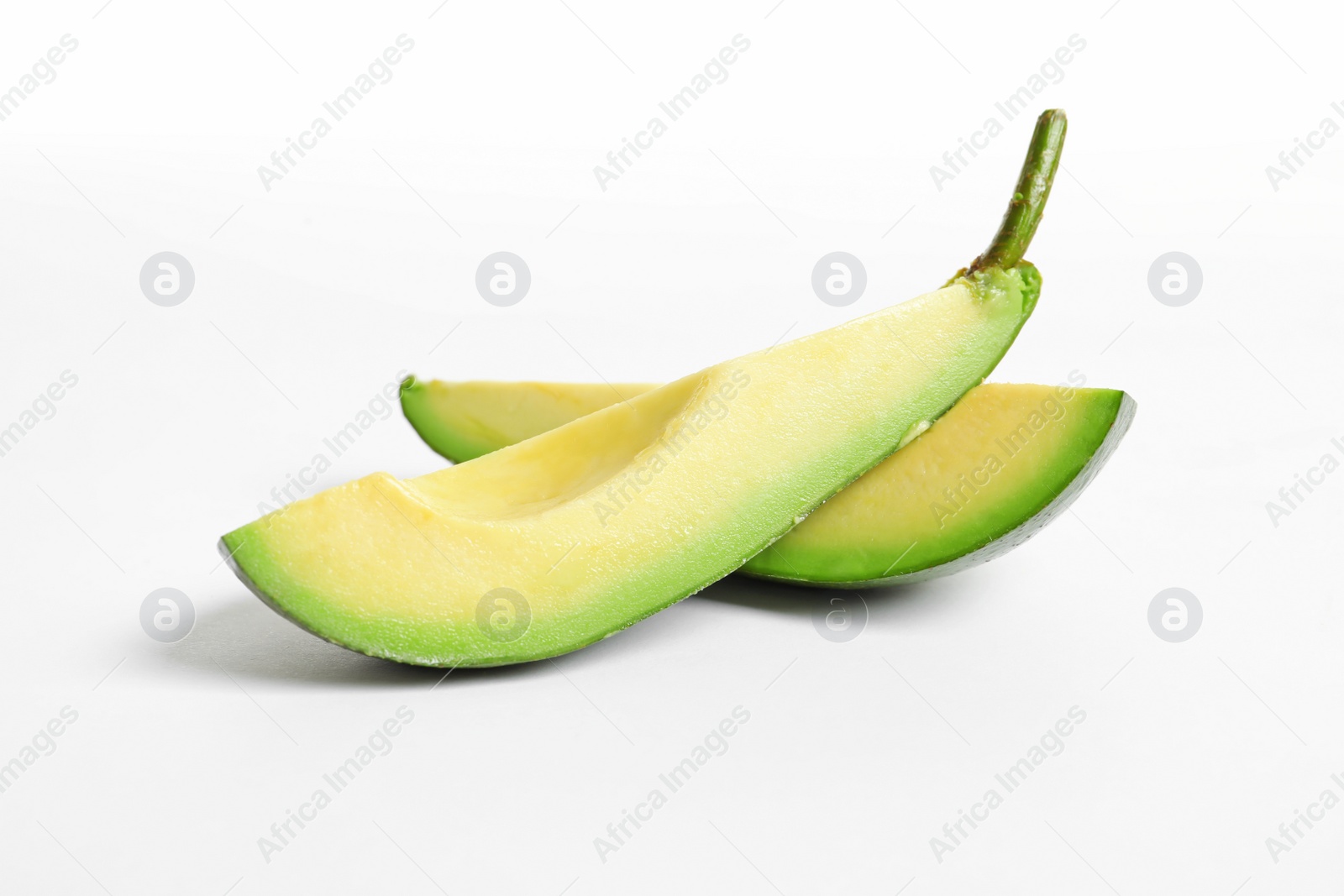 Photo of Slices of avocado on white background