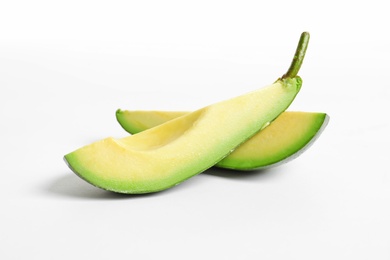 Slices of avocado on white background