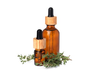 Photo of Bottles of thyme essential oil and fresh plant isolated on white