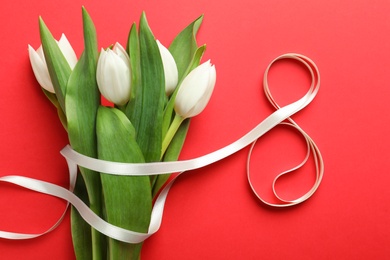 Photo of 8 March card design with tulips on red background, flat lay. International Women's Day