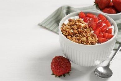 Photo of Yogurt served with granola and strawberries on white wooden table, space for text