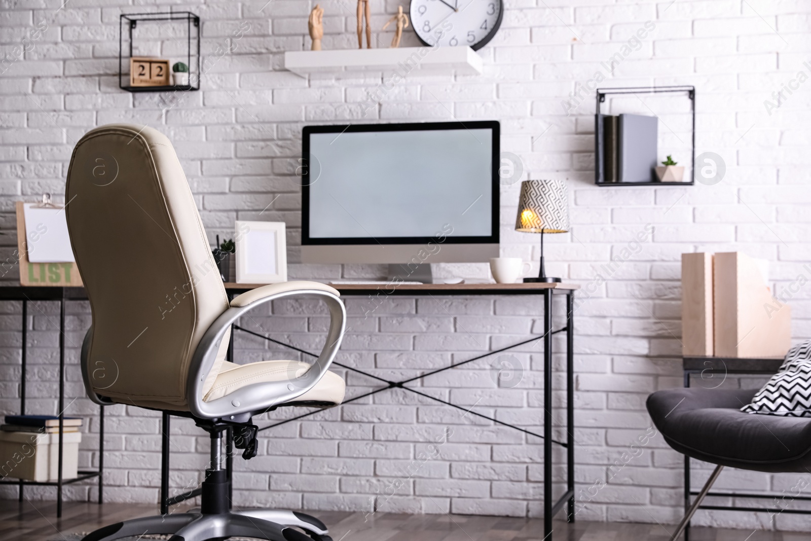 Photo of Comfortable chair near desk in modern office interior