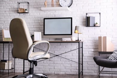 Comfortable chair near desk in modern office interior