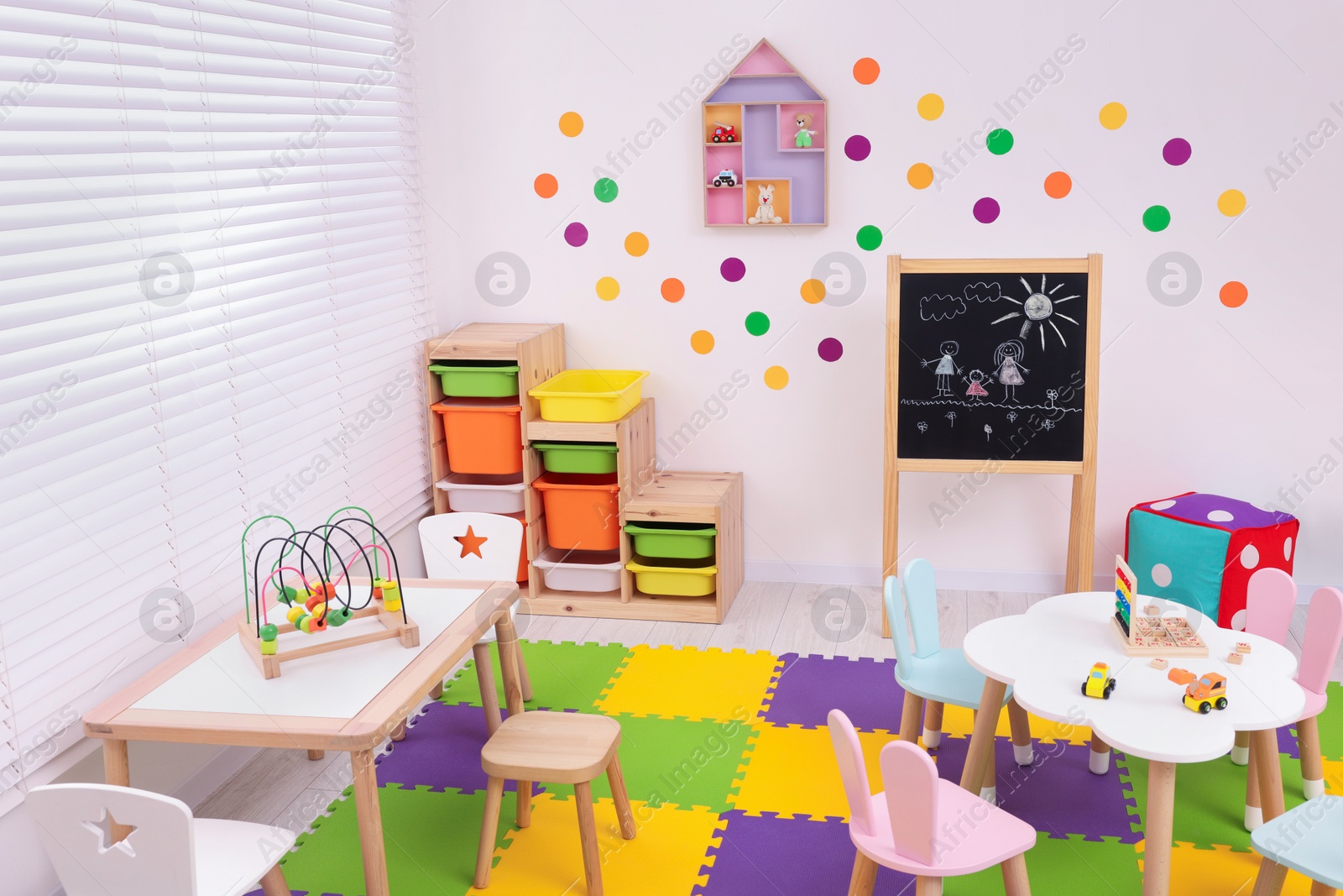 Photo of Stylish kindergarten interior with toys and modern furniture