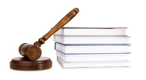 Photo of Wooden gavel and stack of books on white background