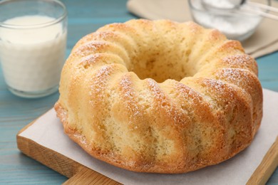 Photo of Delicious freshly baked sponge cake on light blue table, closeup