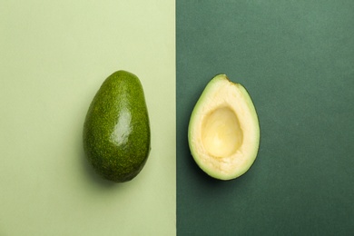 Flat lay composition with ripe avocados on color background