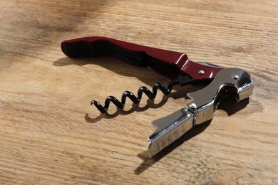 One corkscrew (sommelier knife) on wooden table