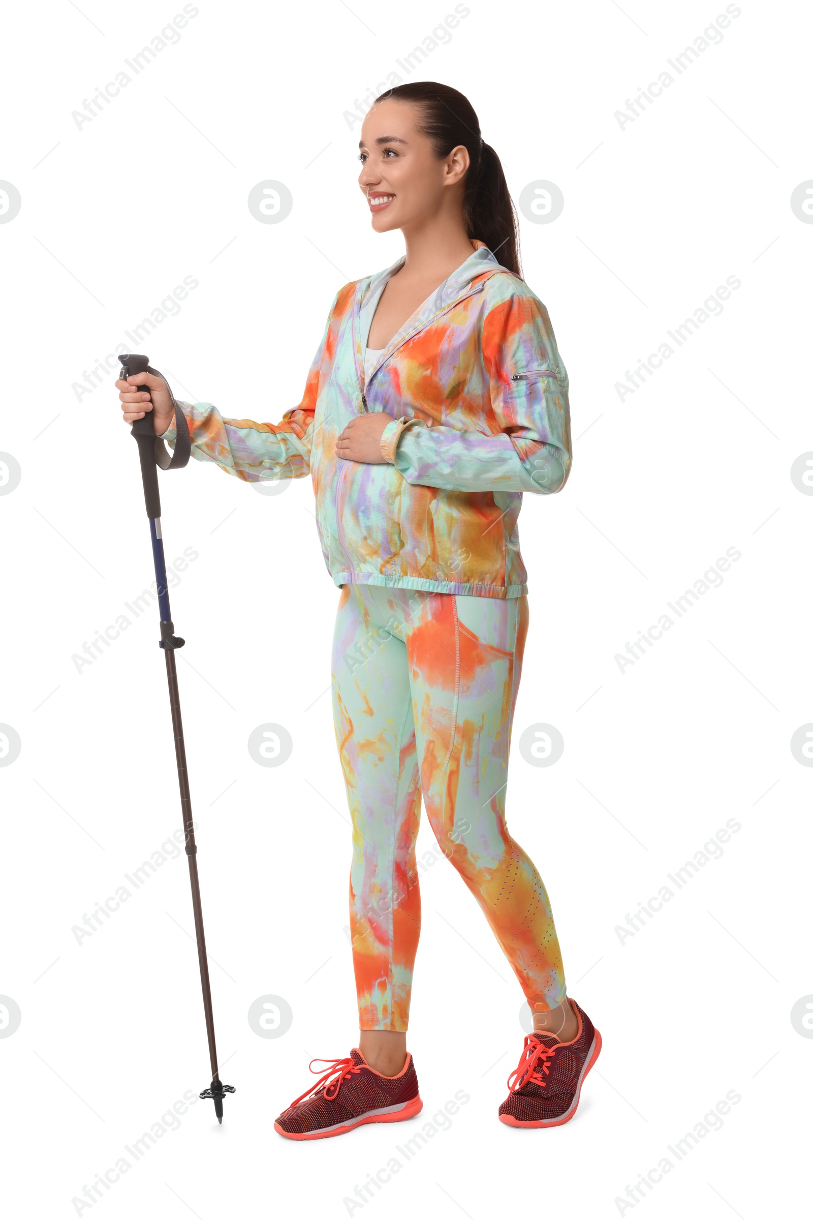 Photo of Pregnant woman practicing Nordic walking with pole isolated on white