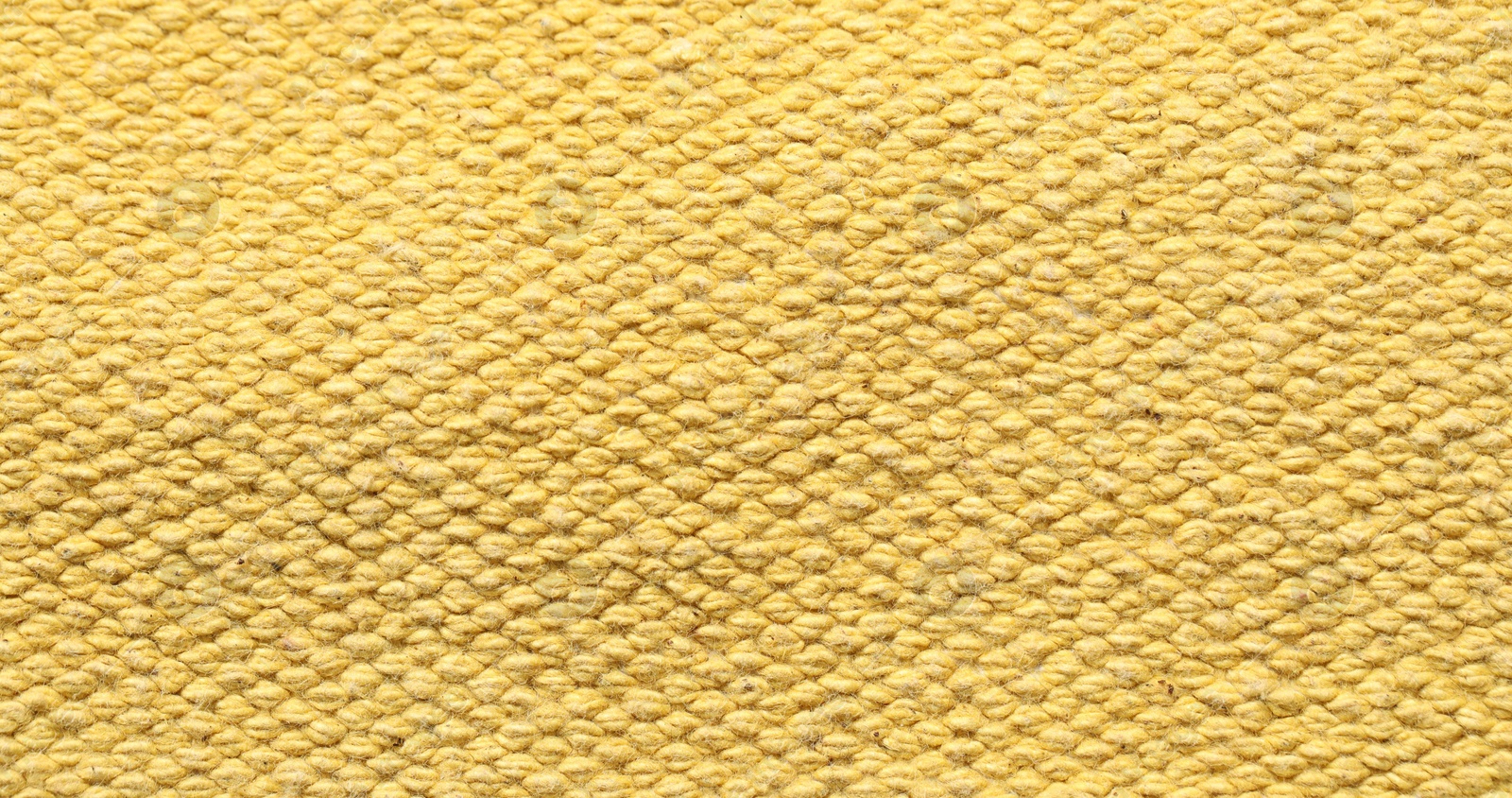 Photo of Texture of soft yellow fabric as background, top view