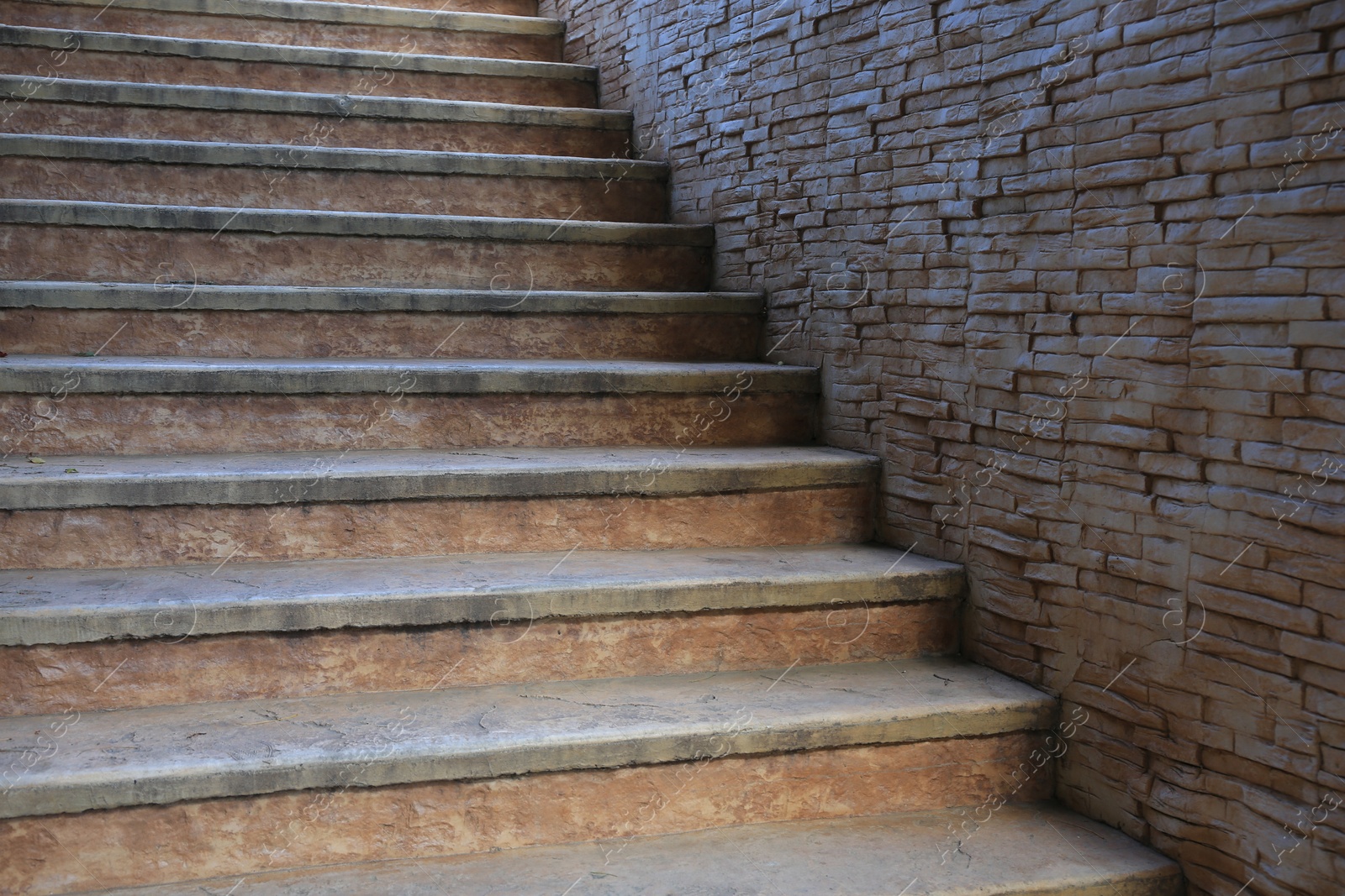 Photo of View of beautiful old stairs near brick wall outdoors