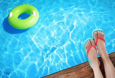Image of Woman wearing stylish flip flops near swimming pool, above view