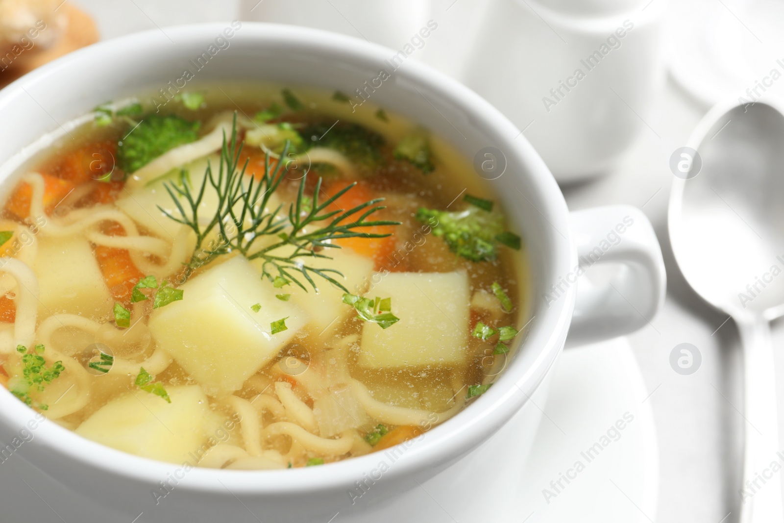 Photo of Dish of fresh homemade vegetable soup on table, closeup