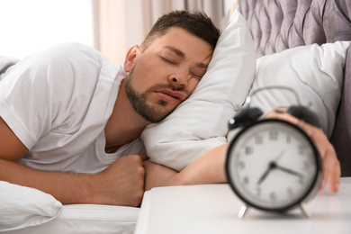 Photo of Handsome man sleeping at home in morning
