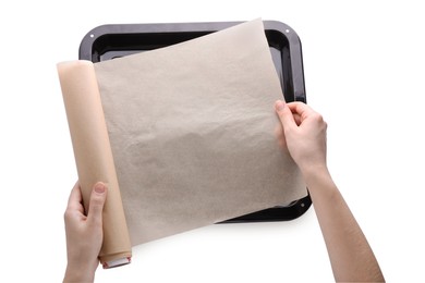 Woman putting parchment paper into baking pan isolated on white, top view