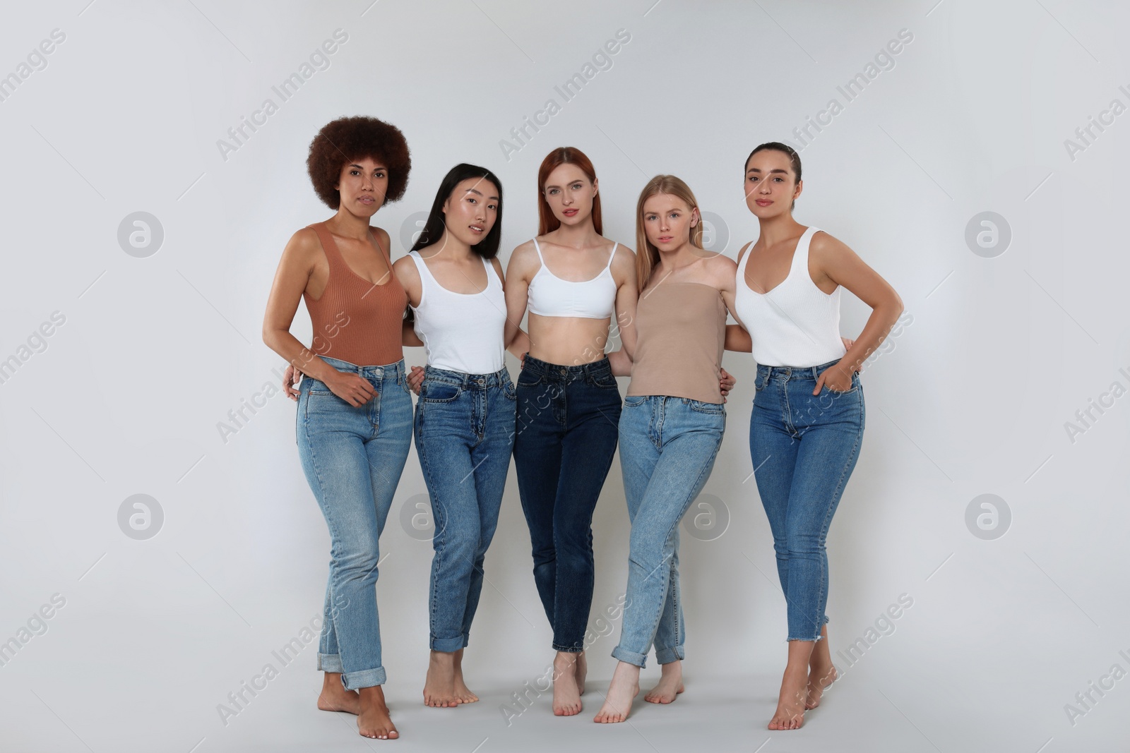 Photo of Group of beautiful young women on light grey background