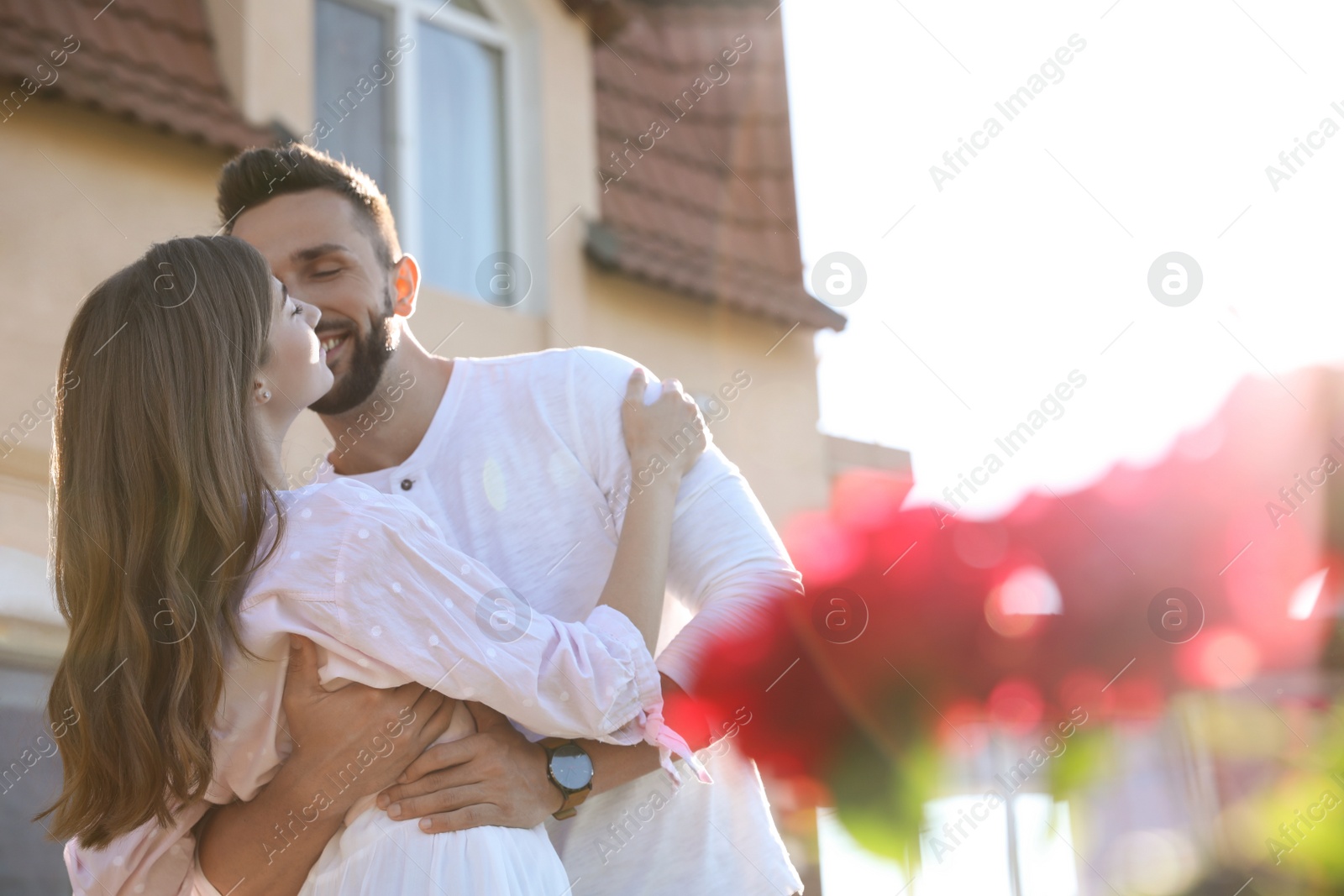 Photo of Lovely young couple dancing together outdoors on sunny day