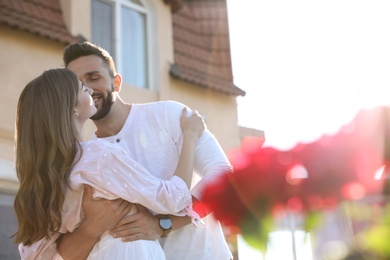 Photo of Lovely young couple dancing together outdoors on sunny day