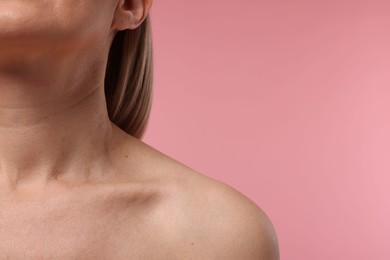 Woman with healthy skin on pink background, closeup. Space for text