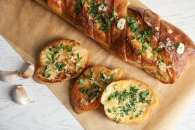 Flat lay composition with homemade garlic bread on table