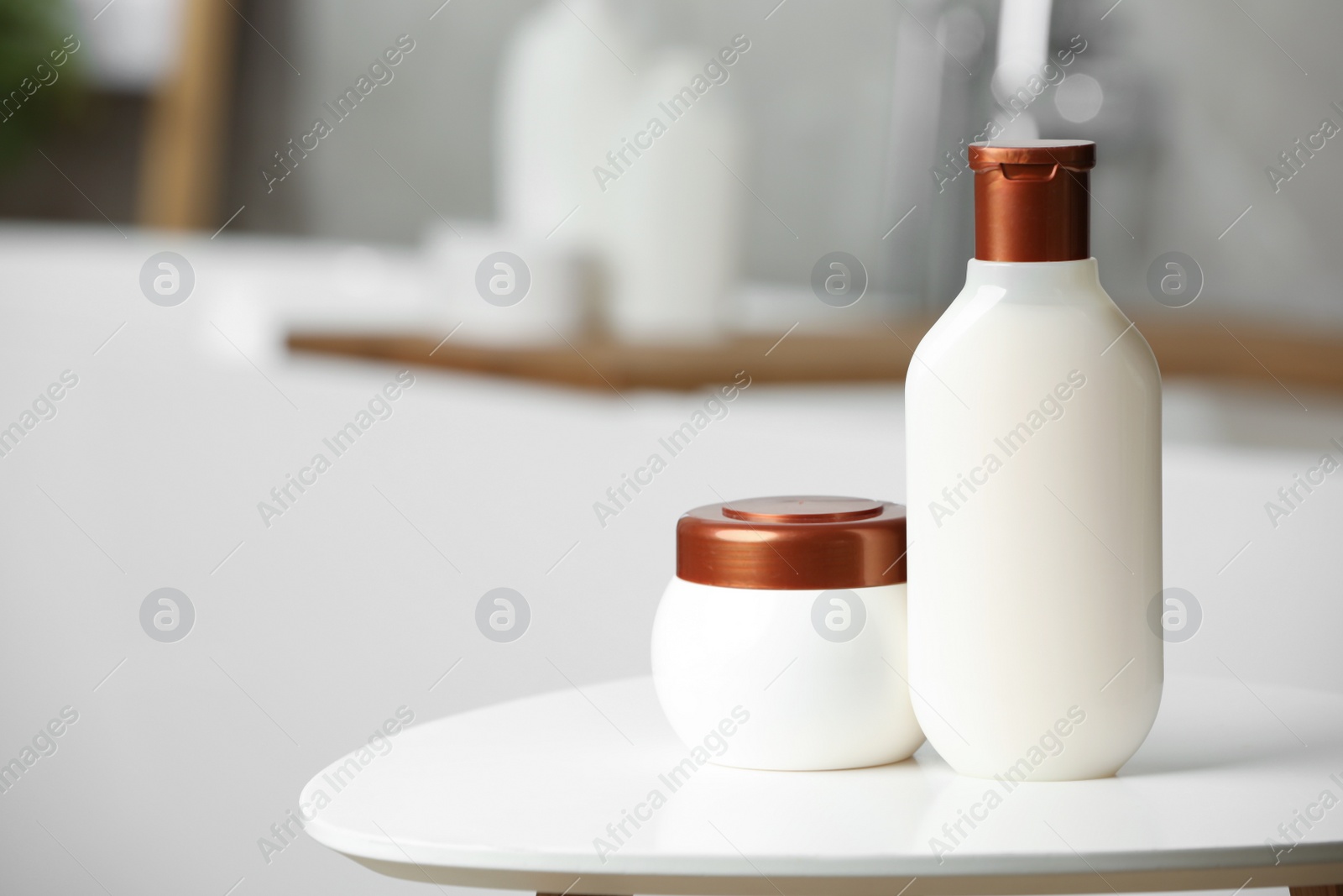 Photo of Shampoo and hair mask on white table in bathroom, space for text