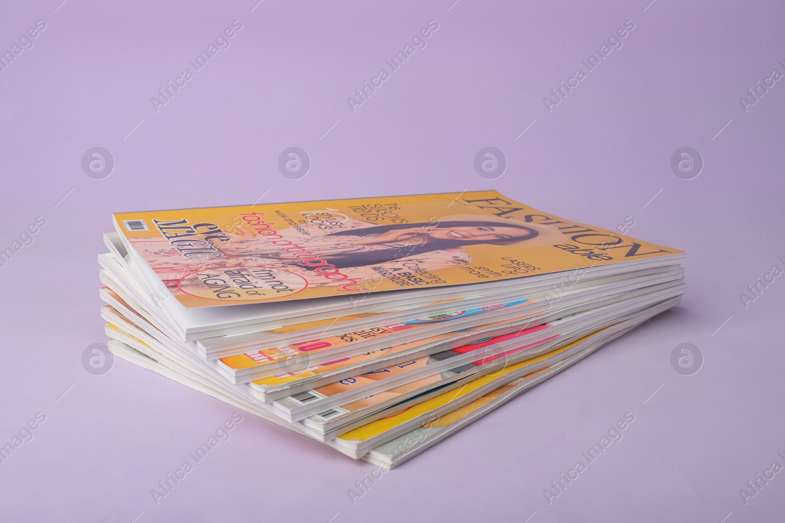 Photo of Group of stacked magazines on violet background