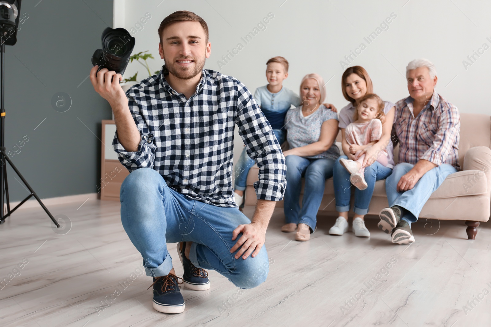 Photo of Professional photographer with camera and family in studio