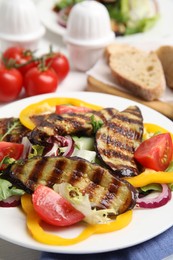 Photo of Delicious salad with roasted eggplant on plate, closeup