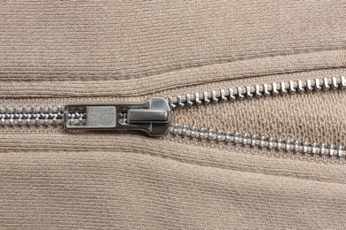 Photo of Beige sweatshirt with zipper as background, top view